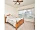 Bright bedroom with a ceiling fan, a large window, and a wooden bed frame at 4905 Britewater Ct. # 202, Myrtle Beach, SC 29579