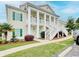 Charming two-story condo featuring white columns and a beautiful staircase leading to the entrance at 4905 Britewater Ct. # 202, Myrtle Beach, SC 29579