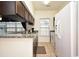 Kitchen view with white appliances, dark cabinets, and granite countertops at 4905 Britewater Ct. # 202, Myrtle Beach, SC 29579