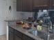 Kitchen features stainless steel sink, granite countertop, and dark cabinets at 4905 Britewater Ct. # 202, Myrtle Beach, SC 29579