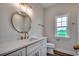 Bathroom featuring a white vanity, modern fixtures, mirror and wood-look flooring at 4975 Dupont Rd., Conway, SC 29526