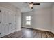 Clean bedroom with wood-look flooring, window and double door closet at 4975 Dupont Rd., Conway, SC 29526