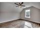 Cozy bedroom featuring wood-look floors, neutral paint, ceiling fan and sloped ceiling at 4975 Dupont Rd., Conway, SC 29526