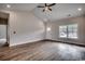 Open-concept living room with hardwood floors, large window, and a white front door at 4975 Dupont Rd., Conway, SC 29526