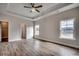 Spacious main bedroom featuring a tray ceiling, wood-look floors and ample natural light at 4975 Dupont Rd., Conway, SC 29526