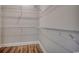 Walk-in closet with metal shelving and wood-look floors provides ample storage space at 4975 Dupont Rd., Conway, SC 29526