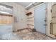 Unfinished basement with storage shelves, access door and adjacent room at 5002 Watergate Dr., Myrtle Beach, SC 29588