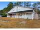 Charming home with white siding, front porch, and mature trees in a tranquil neighborhood at 5002 Watergate Dr., Myrtle Beach, SC 29588