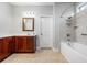 Clean and bright bathroom features a shower-tub, tiled floors, and wood vanity at 5230 Piemonte Ln., Myrtle Beach, SC 29579