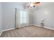 Bedroom featuring carpet floors, ceiling fan, and a large window with curtains at 5230 Piemonte Ln., Myrtle Beach, SC 29579