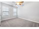 Bedroom with carpet flooring, ceiling fan, and large windows that let in natural light at 5230 Piemonte Ln., Myrtle Beach, SC 29579