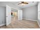 Neutral bedroom with a ceiling fan, hardwood flooring, and a view into the kitchen at 5230 Piemonte Ln., Myrtle Beach, SC 29579