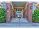 The Tuscany building entrance with elegant brick columns, stairs, and double doors leads into a beautiful building at 5230 Piemonte Ln., Myrtle Beach, SC 29579