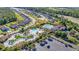 Aerial view of resort-style community pool featuring pools, a lazy river, parking, and lush landscaping at 5230 Piemonte Ln., Myrtle Beach, SC 29579