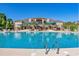 Large community pool surrounded by seating, palm trees, and a luxurious clubhouse offers an escape at 5230 Piemonte Ln., Myrtle Beach, SC 29579