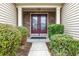 Beautiful entryway with stone and siding, a double-door entrance, and manicured shrubbery at 5230 Piemonte Ln., Myrtle Beach, SC 29579