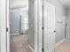 Hallway view to bedroom and bathroom showing tile and carpet flooring at 5230 Piemonte Ln., Myrtle Beach, SC 29579