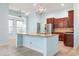 Open kitchen with a large island, stainless steel appliances, granite countertops, and wooden cabinetry at 5230 Piemonte Ln., Myrtle Beach, SC 29579