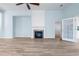 Inviting living room featuring a fireplace, hardwood floors, and French doors at 5230 Piemonte Ln., Myrtle Beach, SC 29579