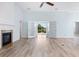 Open living space showcasing a fireplace, hardwood floors, and French doors to the outside at 5230 Piemonte Ln., Myrtle Beach, SC 29579