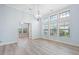 Open living space featuring a modern chandelier and multiple windows for an abundance of light at 5230 Piemonte Ln., Myrtle Beach, SC 29579