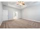 The main bedroom features plush carpet flooring, an open doorway to the ensuite bathroom, and a ceiling fan at 5230 Piemonte Ln., Myrtle Beach, SC 29579