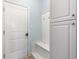 Mudroom with a built-in bench, storage cabinets, and a door to the exterior at 5230 Piemonte Ln., Myrtle Beach, SC 29579
