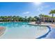 Inviting community pool area with ample seating, palm trees, and a well-maintained pool house at 5230 Piemonte Ln., Myrtle Beach, SC 29579