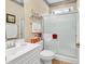 Cozy bathroom with tiled floors features a shower with glass doors and a white single sink vanity at 537 Sand Ridge Rd., Conway, SC 29526