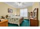 Bright bedroom features a full-size bed with a floral comforter, ceiling fan, and natural light at 537 Sand Ridge Rd., Conway, SC 29526