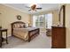 Comfortable bedroom with a wooden bed frame, a ceiling fan, and natural light from the windows at 537 Sand Ridge Rd., Conway, SC 29526