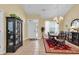 Traditional dining room with tile flooring features a chandelier, a black china cabinet, and a round wooden table at 537 Sand Ridge Rd., Conway, SC 29526