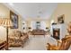 This living room includes a fireplace, carpet, and large windows with natural light at 537 Sand Ridge Rd., Conway, SC 29526