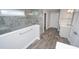 Modern bathroom featuring a glass shower, a vanity and gray wood-style flooring at 546 Haven View Way, Murrells Inlet, SC 29576