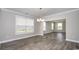 Open dining area with gray floors and stylish chandelier, filled with natural light at 546 Haven View Way, Murrells Inlet, SC 29576