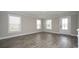 Spacious living room featuring gray wood-look tile flooring and plenty of natural light at 546 Haven View Way, Murrells Inlet, SC 29576