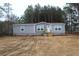 Charming single-story home with gray siding, white trim, and a neatly landscaped front yard at 5810 Hwy 9, Nichols, SC 29581