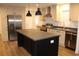 A modern kitchen featuring stainless steel appliances, a black kitchen island, and gray countertops at 5810 Hwy 9, Nichols, SC 29581