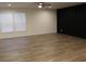 Modern living room showcasing wood-look floors, black accent wall, and natural light at 5810 Hwy 9, Nichols, SC 29581