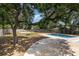 Spacious backyard with a pool, basketball court, and an overhanging tree with a swing at 5811 Sumter Dr., Myrtle Beach, SC 29577