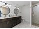 Bathroom boasts double vanities with marble floors, a shower and a separate toilet at 5811 Sumter Dr., Myrtle Beach, SC 29577