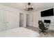 Modern bedroom with white walls, wood floors, and a ceiling fan with additional doorways to other rooms at 5811 Sumter Dr., Myrtle Beach, SC 29577