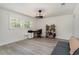 Bonus room showcasing wood flooring, natural light, desk, bookcase and a cozy seating area at 5811 Sumter Dr., Myrtle Beach, SC 29577