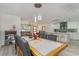 Bright dining area boasts modern pendant lighting, seating for six, and views into the kitchen and living room at 5811 Sumter Dr., Myrtle Beach, SC 29577