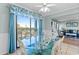 Bright dining area with glass-top table with a view of the living room and exterior at 5905 S Kings Hwy. # 327 A, Myrtle Beach, SC 29575