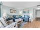 Comfortable living room featuring blue sofas, patterned armchair, and nautical decor at 5905 S Kings Hwy. # 327 A, Myrtle Beach, SC 29575