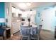 Bright dining area and kitchen featuring white appliances, lovely decor, and beach accents at 5905 South Kings Hwy. # 706, Myrtle Beach, SC 29575