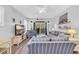 Bright living room featuring comfortable striped seating, a ceiling fan, and access to an outdoor deck at 65 Lakeside Dr. # 65A, Pawleys Island, SC 29585