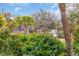 Scenic view showcasing lush greenery, palm trees, and water feature with community buildings in the background at 65 Lakeside Dr. # 65A, Pawleys Island, SC 29585