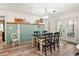 Dining room with wainscotting, wood floors, and stylish chandelier at 705 11Th Ave. S, North Myrtle Beach, SC 29582